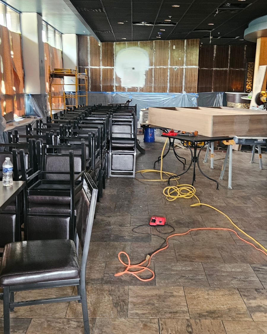 The dining room mid-renovation, chairs in and the bar being built