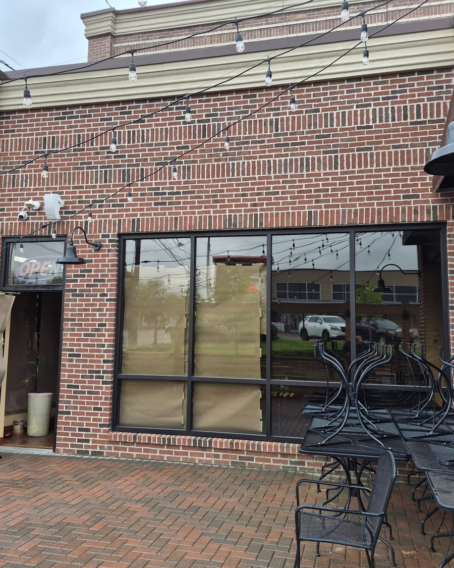 The brick exterior and front patio of the restaurant